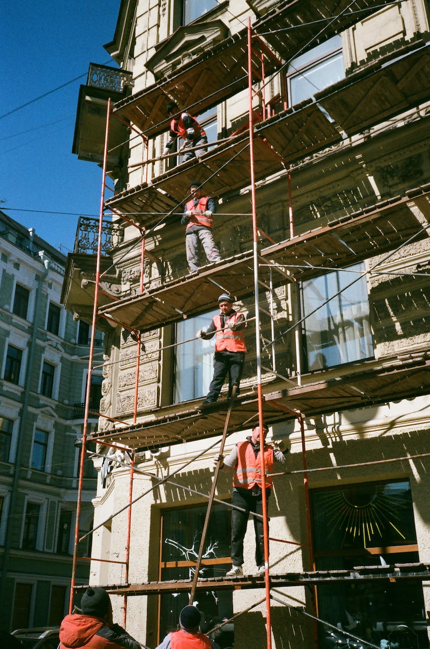 men on brown scaffolding